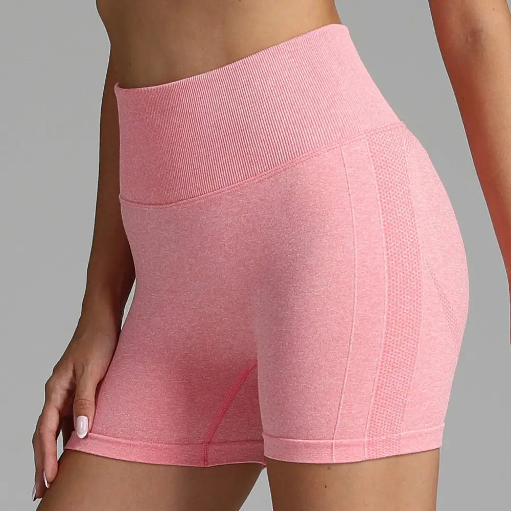 Pink high waist seamless yoga shorts with ribbed waistband and mesh paneling for women’s athletic wear