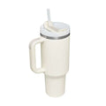 Cream-colored pink kiss insulated tumbler with steel handle straw silver rim and white lid for hot and cold drinks