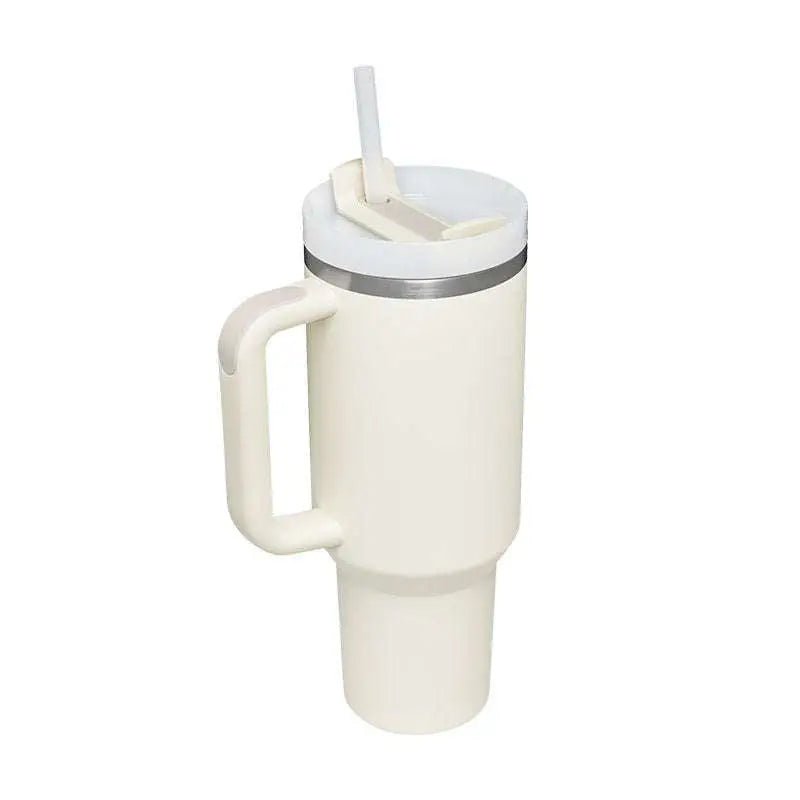 Cream-colored pink kiss insulated tumbler with steel handle straw silver rim and white lid for hot and cold drinks