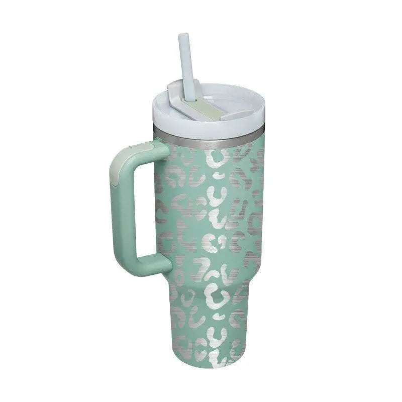 A mint green insulated tumbler with silver leopard print and a white lid and steel handle straw from Pink Kiss