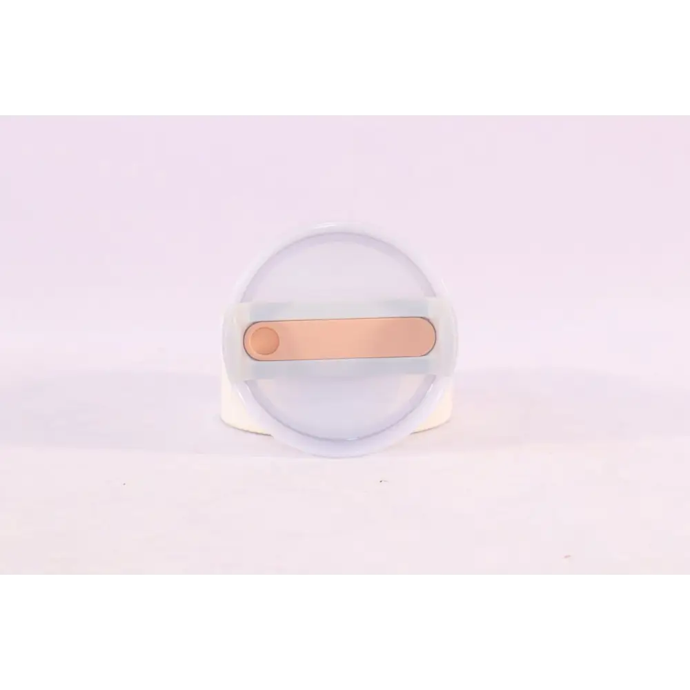 A sleek translucent white silicone phone stand with rose gold accent designed for pink kiss insulated tumbler users