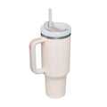 Cream-colored insulated tumbler with pink kiss steel handle straw and white lid for temperature retention