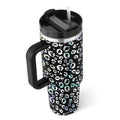 Black insulated tumbler with steel handle straw featuring pink kiss iridescent leopard print in white and teal accents
