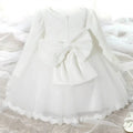 Back view of a pink lace princess dress girls summer style with white lace and tulle featuring a large bow