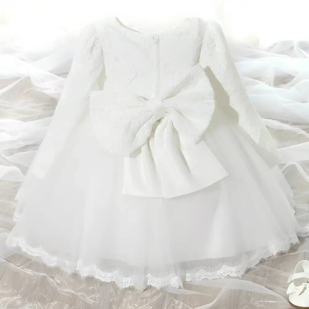 Back view of a pink lace princess dress girls summer style with white lace and tulle featuring a large bow