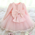 Back view of a delicate pink lace princess dress girls summer long sleeve tulle with an oversized bow at the back