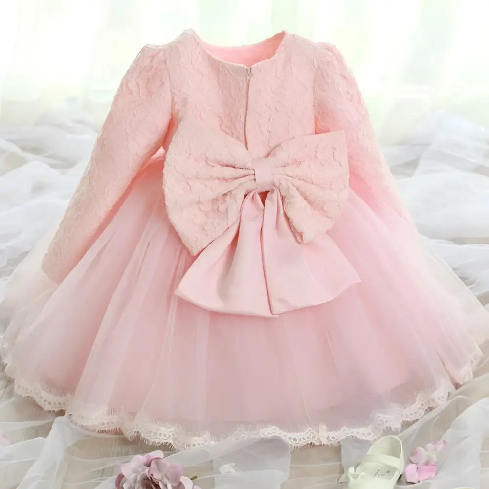 Back view of a delicate pink lace princess dress girls summer long sleeve tulle with an oversized bow at the back