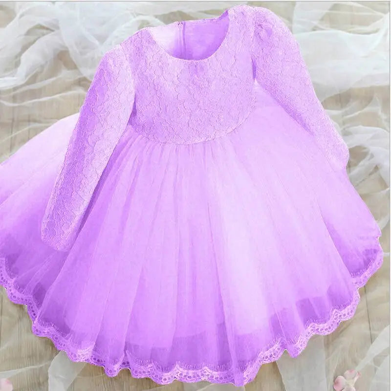 A delicate pink lace princess dress for girls with long sleeves made of lace and tulle for summer wear