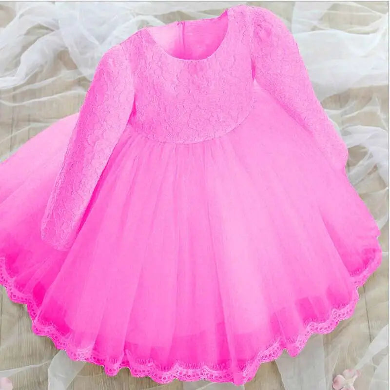 A vibrant pink lace princess dress girls long sleeve with layered tulle skirt and delicate lace trim hem