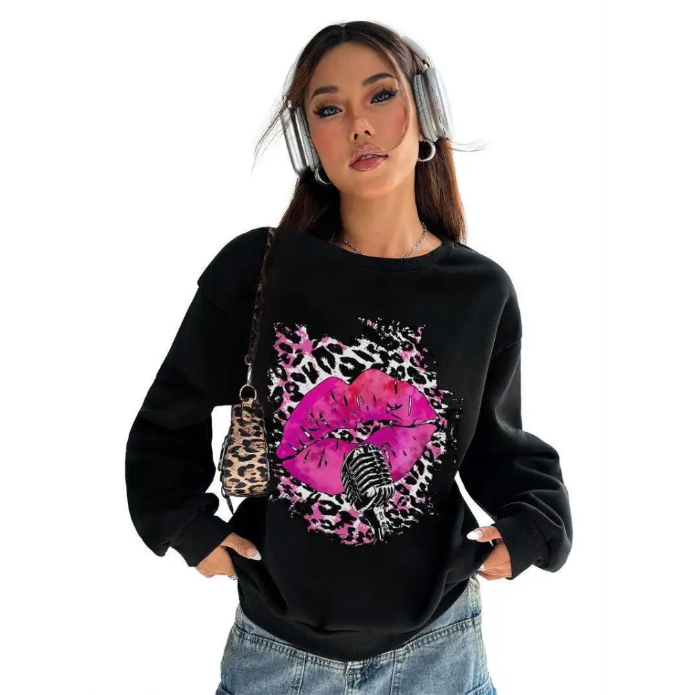 Black long-sleeved oversized crew neck sweatshirt featuring pink lips and vintage microphone on leopard print background