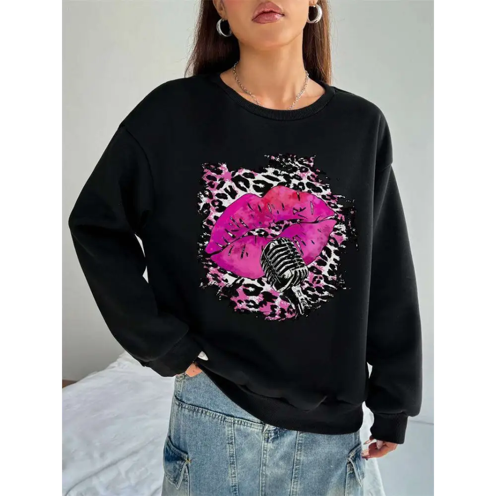 Black oversized crew neck sweatshirt with pink lips and vintage microphone graphic on leopard print background