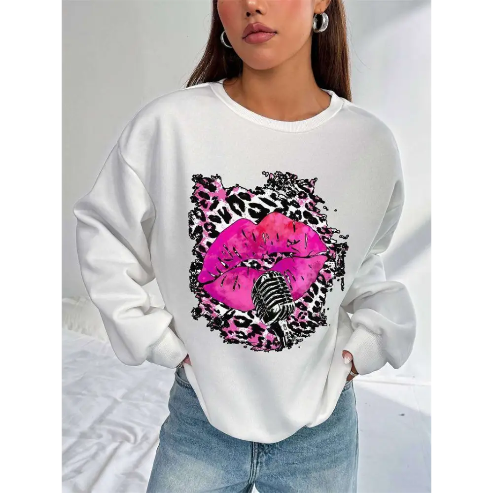 White oversized crew neck sweatshirt with bold pink lips graphic and vintage microphone framed by black and pink leopard print