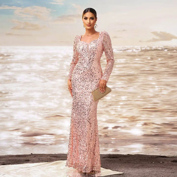 A shimmering pink long sleeve sequined sheath fishtail evening dress with floor-length and square neckline