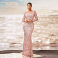 A shimmering pink long sleeve sequined sheath fishtail evening dress with a square neckline and fitted silhouette