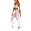 A pair of light pink high-waisted women workout sets leggings with pink mesh contrast and white side stripes for home wearing