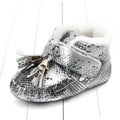 Silver snake-print baby shoes with white faux fur lining and gold-toned tassel accents for toddlers