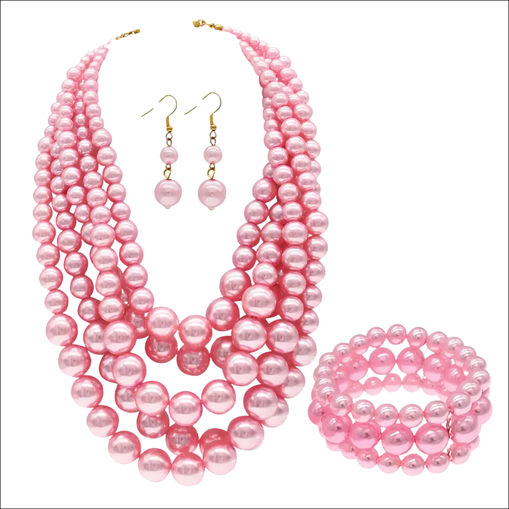 Pink multi strand pearl jewelry set featuring necklace, matching earrings, and bracelet in costume jewelry set design