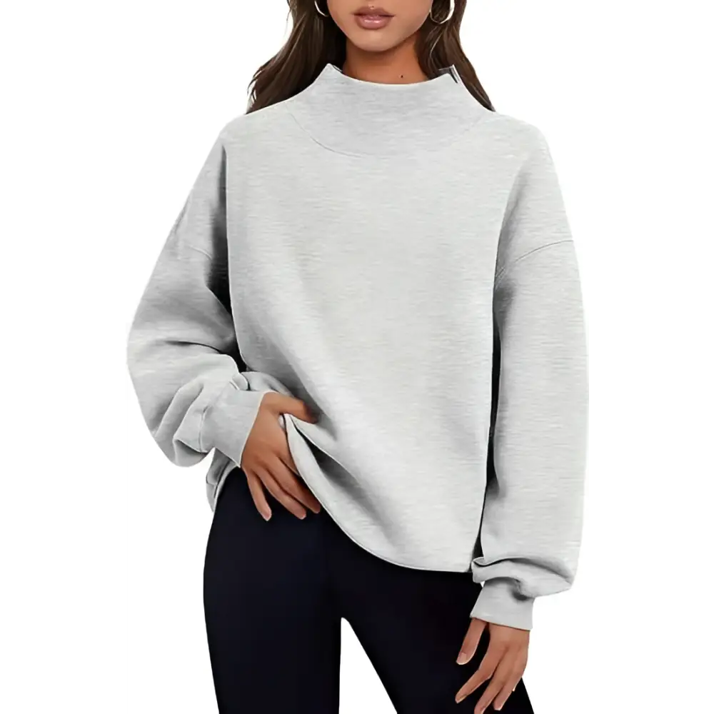A soft heather gray pullover sweatshirt solid with ribbed cuffs and a high neckline in a relaxed fit design