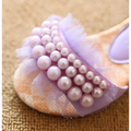 A soft peach slip-on sandal featuring delicate lavender mesh summer girls with pink pearl mesh embellishments