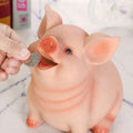 Pink pig piggy bank plastic money box with orange snout and feet made of smooth plastic for savings use