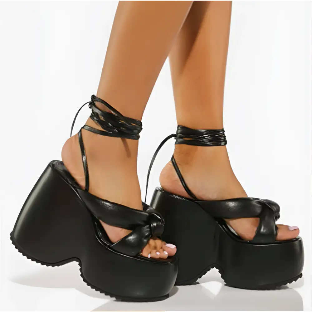 Black platform wedge sandals with thick chunky soles and crisscross ankle tie straps for stylish wear