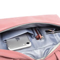 Pink pu leather women laptop bag with minimalist design showing quilted exterior and gray interior holding iphone and pens