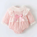 Pink ribbed long sleeve newborn clothes jumpsuit with lace trim ruffles and a matching pink satin bow at the front