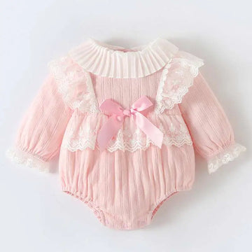 Pink ribbed long sleeve newborn clothes jumpsuit with lace trim ruffles and a matching pink satin bow at the front