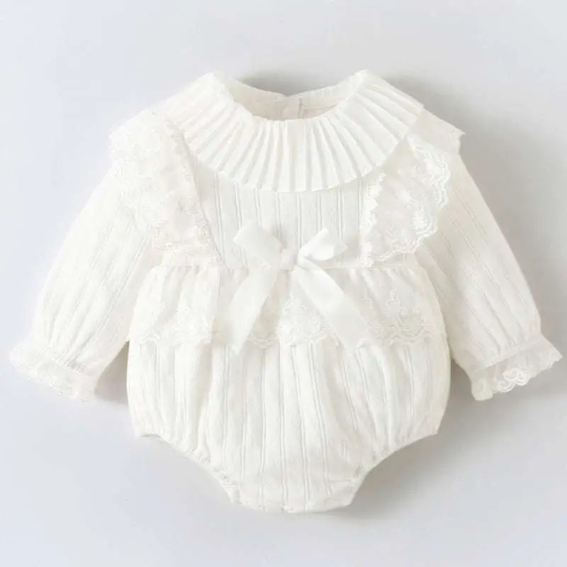 White ribbed newborn clothes jumpsuit with lace trim and central bow in pink ribbed long sleeve design