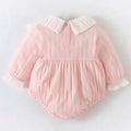 A soft pink ribbed long newborn clothes jumpsuit with white pleated collar and lace trim at the cuffs