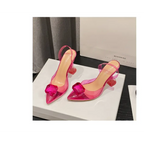 Pink satin bow women’s high-heeled sandal featuring transparent pink straps and crystal-like square toe embellishment
