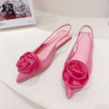 Pink satin floral embellished backless flat sandal with large glossy rose floral embellishment at the toe