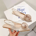 Beige satin floral embellished backless flat sandal with a delicate rose embellishment on the toe