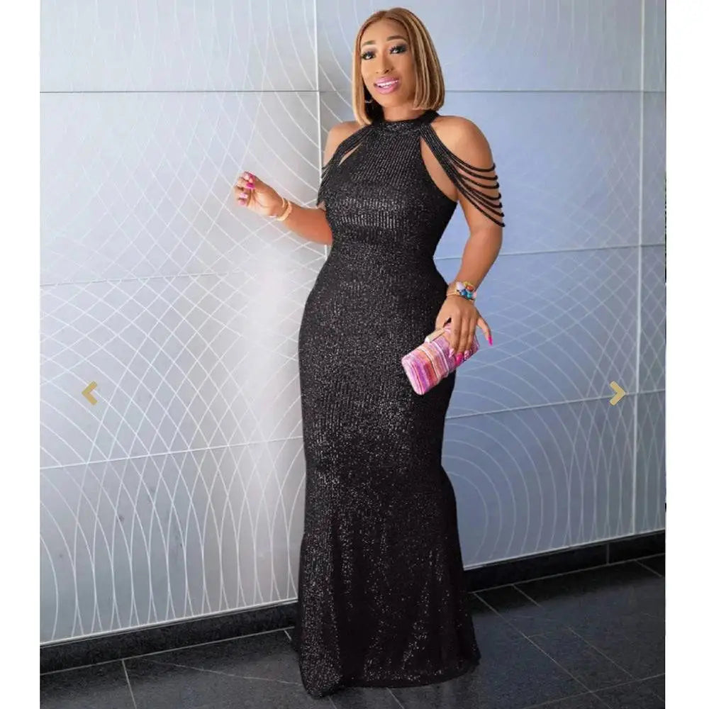 A shimmering black sequined high stretch dress with high neckline and cut-out shoulder straps showcasing african ladies