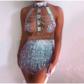 A pink sequined fringe night club mini skirt with iridescent sequins paired with a metallic chain leather harness top