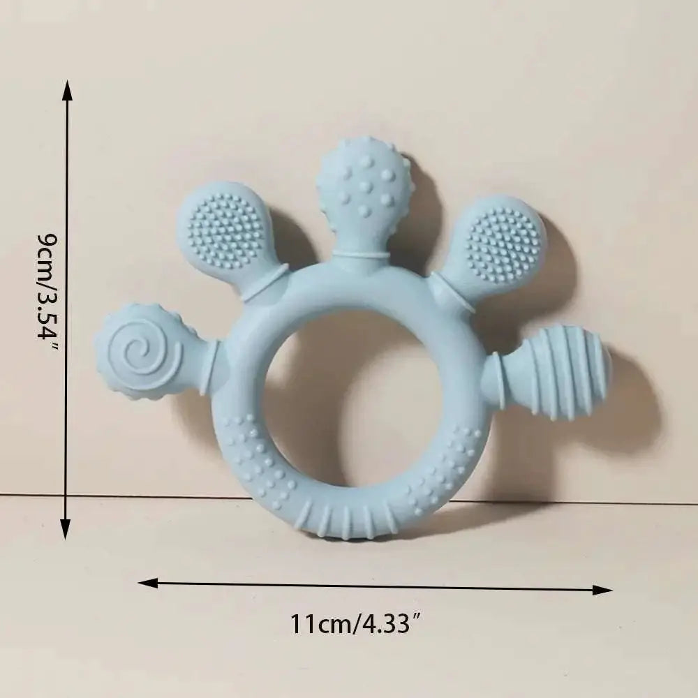 Light blue silicone baby hand teether with textured rounded protrusions featuring dots and swirls for soothing gums