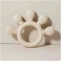 Pink silicone baby hand teether made of white silicone with five textured cartoon-themed protrusions including bee and snail