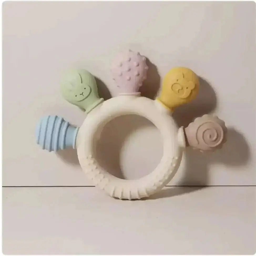 Pink silicone baby hand teether with pastel-colored silicone baby hand textured protrusions for soothing gums