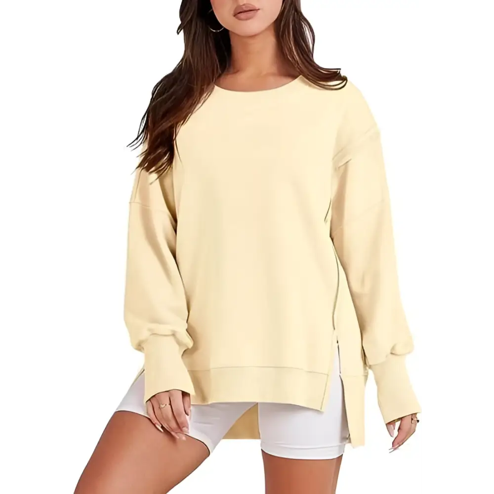 A soft pale yellow oversized sweatshirt crew neck design with relaxed fit and side slit detailing for casual wear