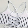 White and black striped bikini top with crisscross straps and lace-up back detail for a striped bikini split design
