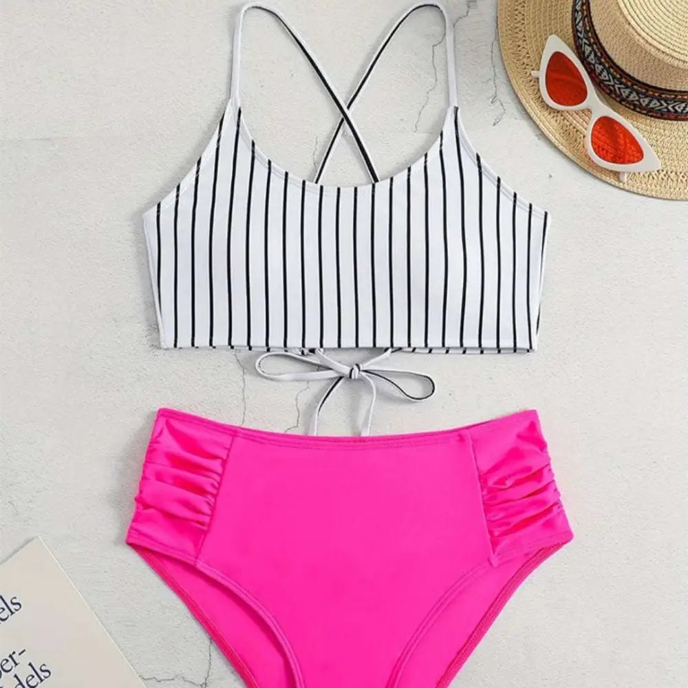 Pink high-waisted bikini bottom with ruched side panels featuring black vertical stripes in a striped bikini split design