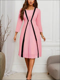 Pink striped pleated midi dress with soft pink fabric black vertical pleated panels and v-neckline in luxury women’s fashion
