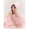 A soft pink tiered tulle dress with a strapless bodice and flowing skirt from fairy temperament main yarn