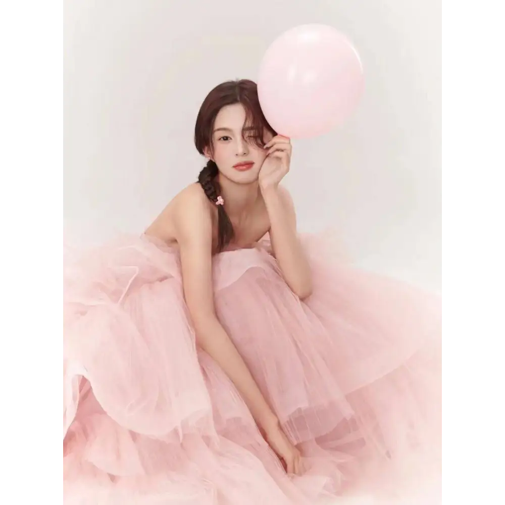 A soft pink tiered tulle dress with a strapless bodice and flowing skirt from fairy temperament main yarn
