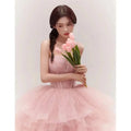 A soft pink tiered tulle dress with a structured bodice and layered ruffles from fairy temperament main yarn