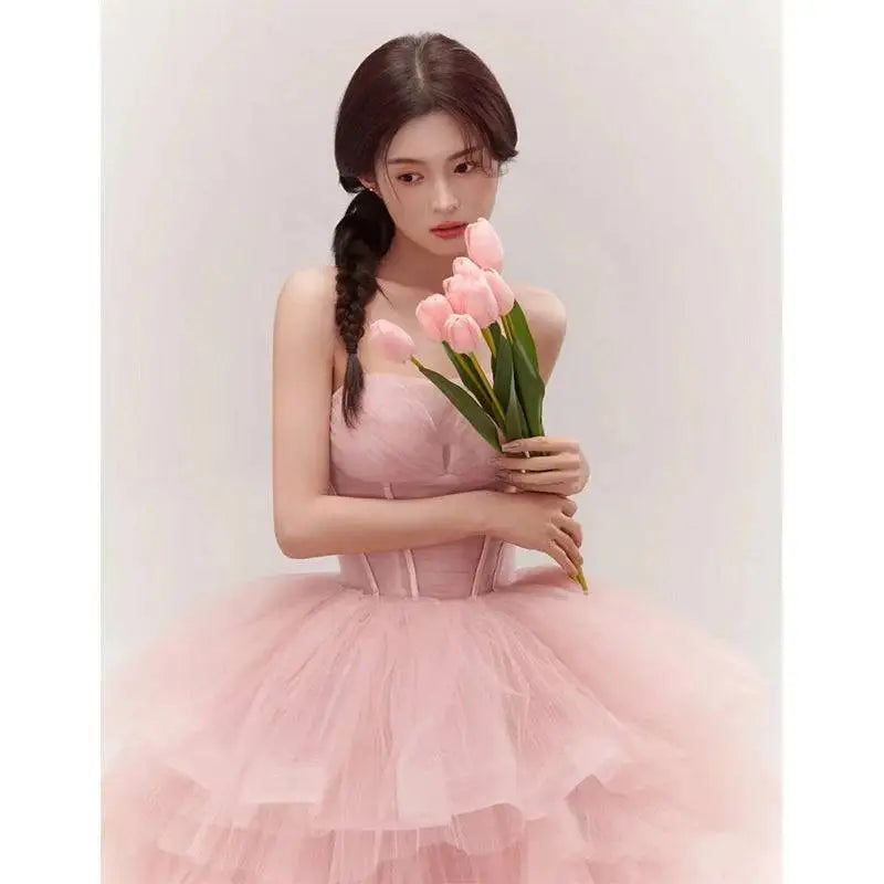 A soft pink tiered tulle dress with a structured bodice and layered ruffles from fairy temperament main yarn