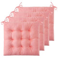 Set of four pink tufted chair cushions with fabric ties designed as comfortable tufted chair pads