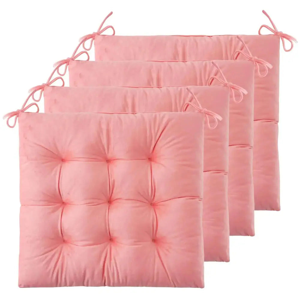 Set of four pink tufted chair cushions with fabric ties designed as comfortable tufted chair pads