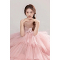 A soft pink tulle wedding photography dress with layered voluminous skirt and delicate floral embellishment on bodice