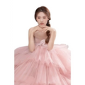 A soft pink tulle wedding photography dress with a fitted bodice and voluminous multi-layered skirt